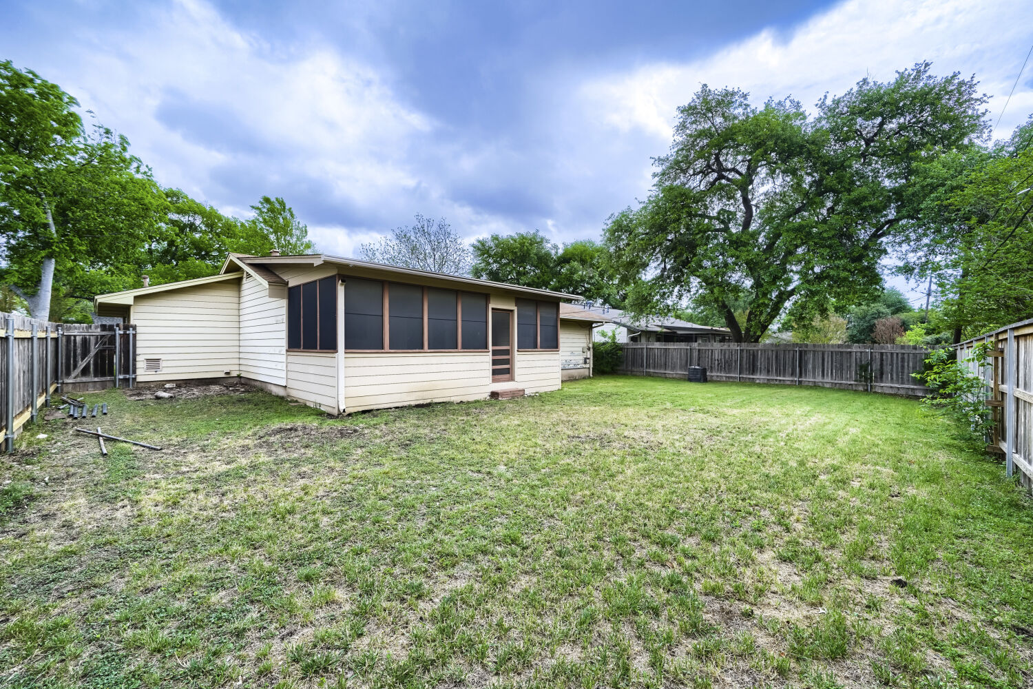 1909 Burbank Street Austin, TX 78757 - Photo 15 of 17 a backyard of a house with lots of green space