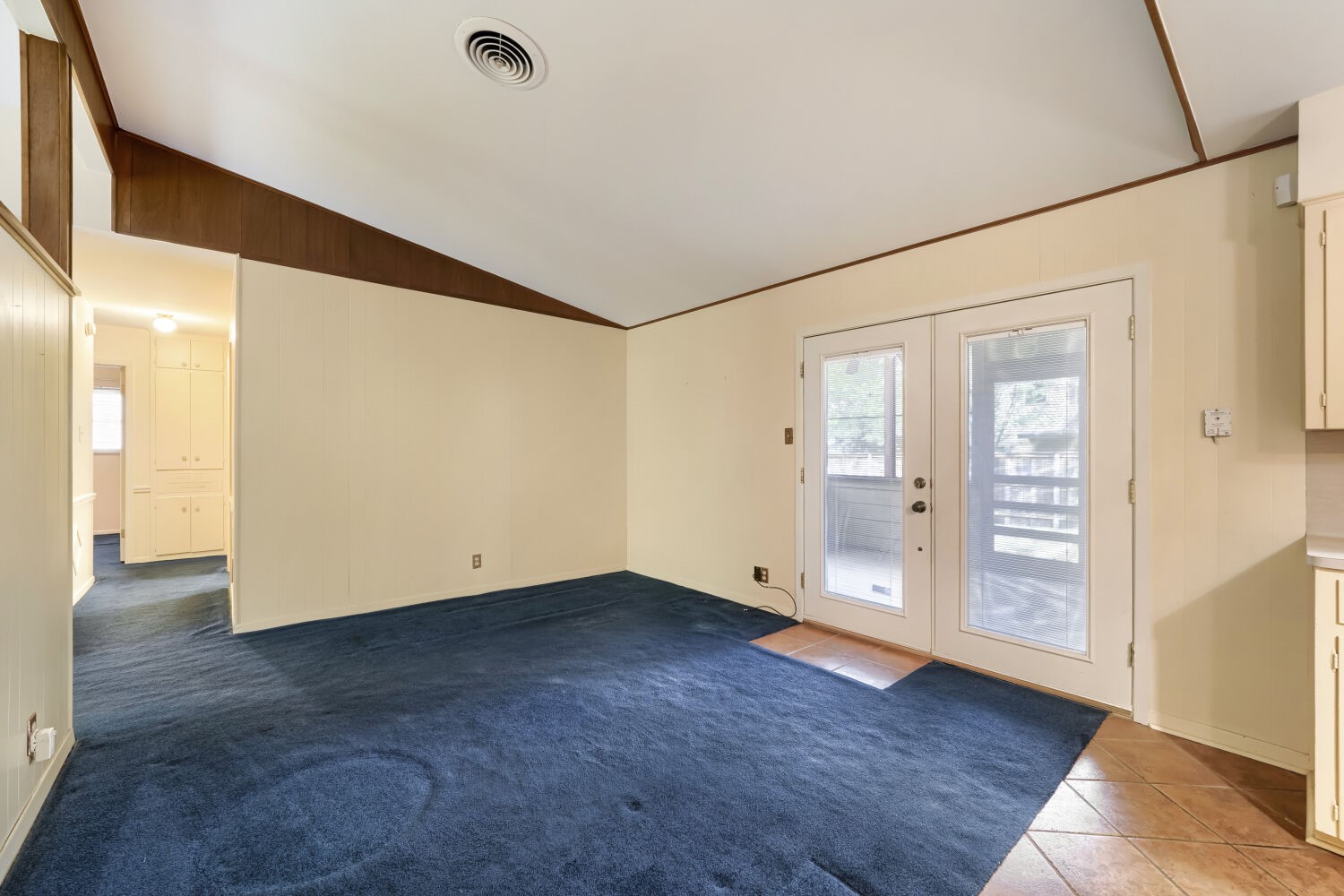 1909 Burbank Street Austin, TX 78757 - Photo 7 of 17 a view of an empty room with wooden floor and a window