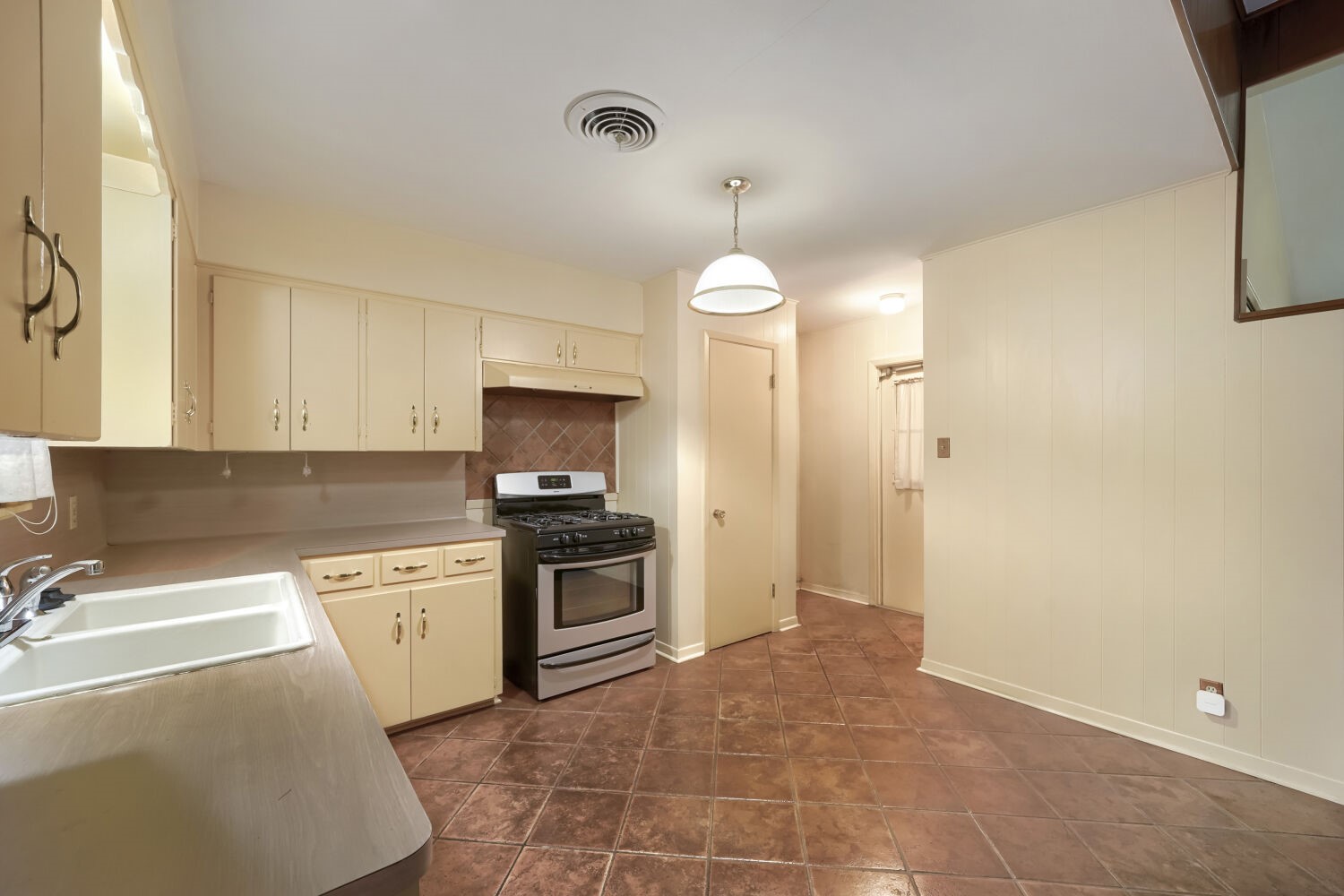 1909 Burbank Street Austin, TX 78757 - Photo 8 of 17 a kitchen with granite countertop a sink a stove top oven and cabinetry
