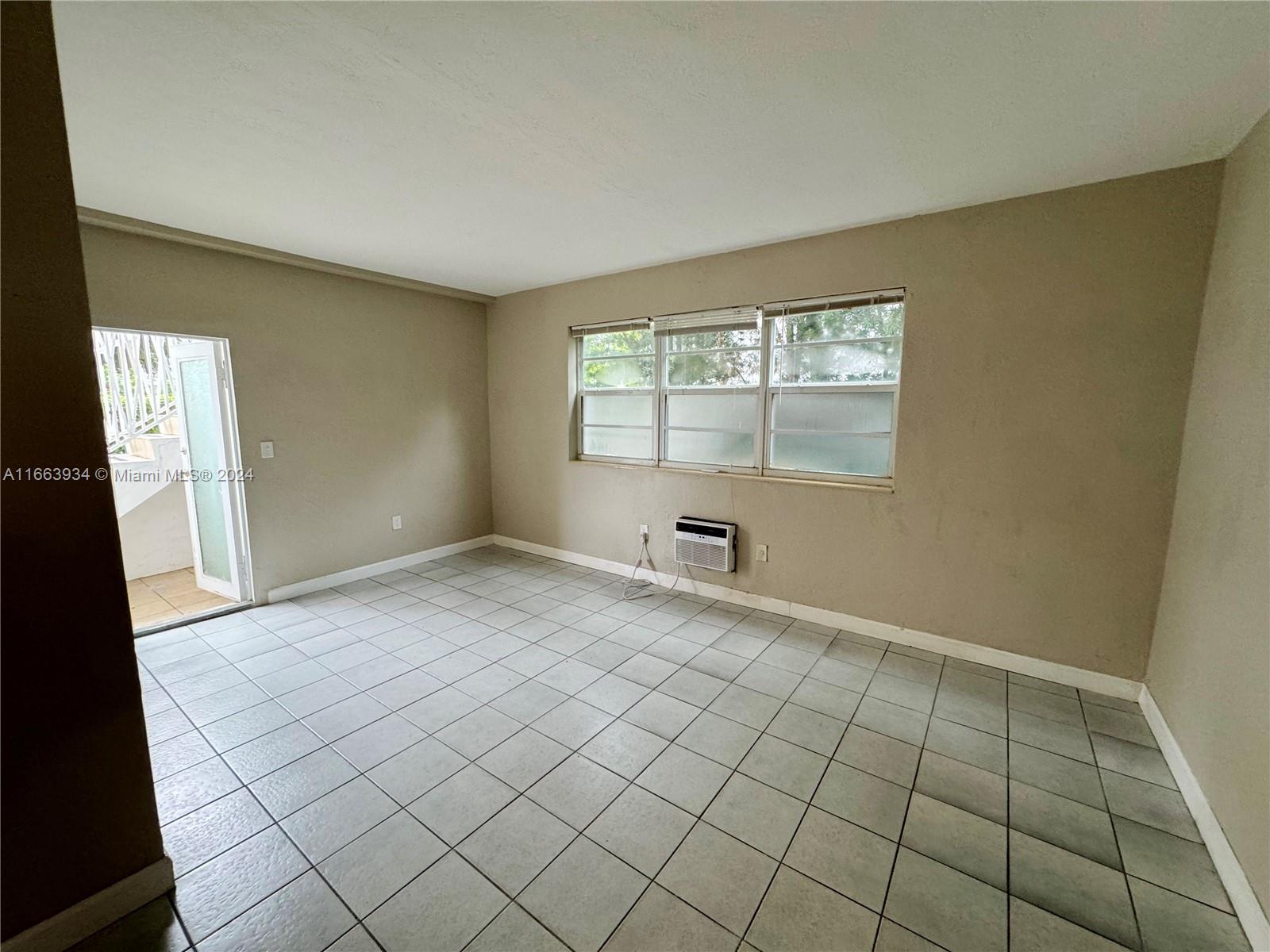 620 76th Street, Unit 7 Miami Beach, FL 33141 - Photo 11 of 17 an empty room with windows