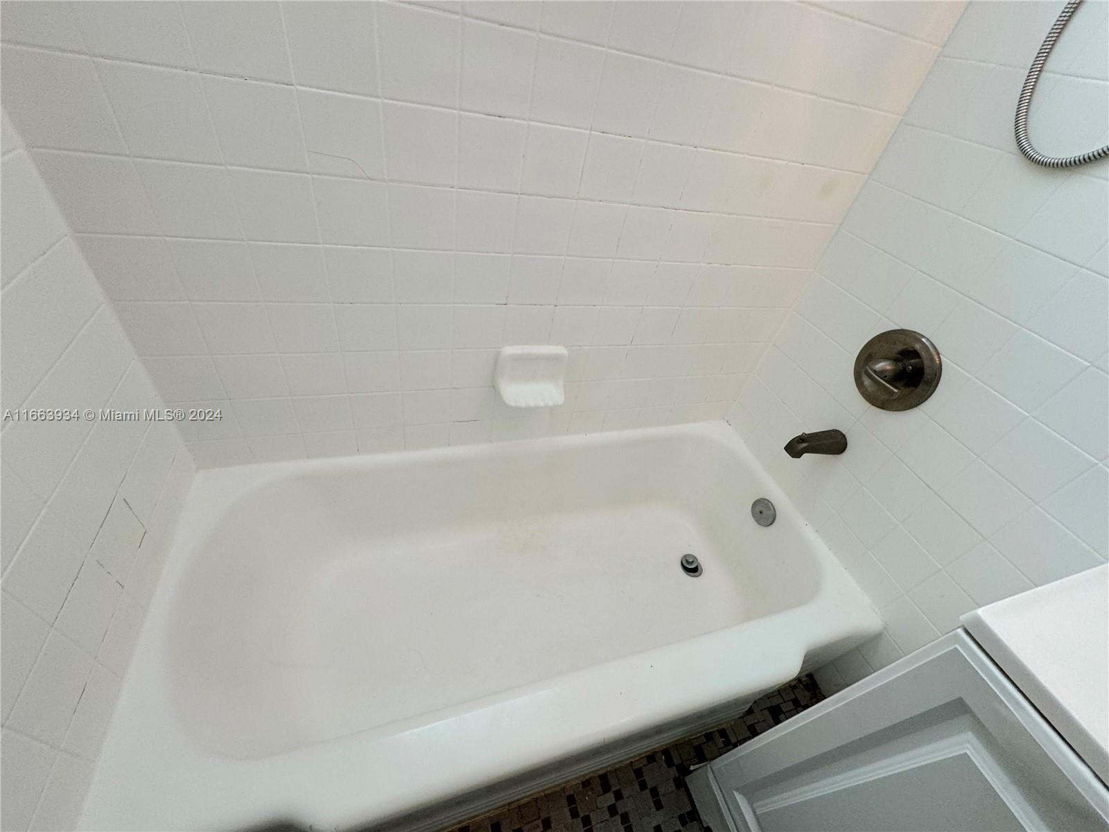620 76th Street, Unit 7 Miami Beach, FL 33141 - Photo 16 of 17 a bathroom with a tub and a shower
