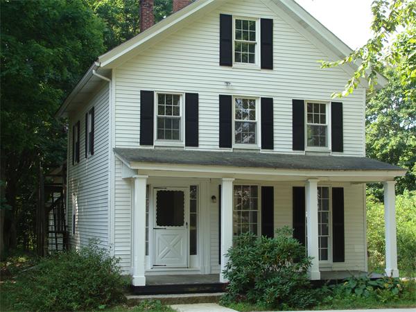 478 Gleasondale Road Stow, MA 01775 - Photo 1 of 1 a view of a house with brick walls and potted plants