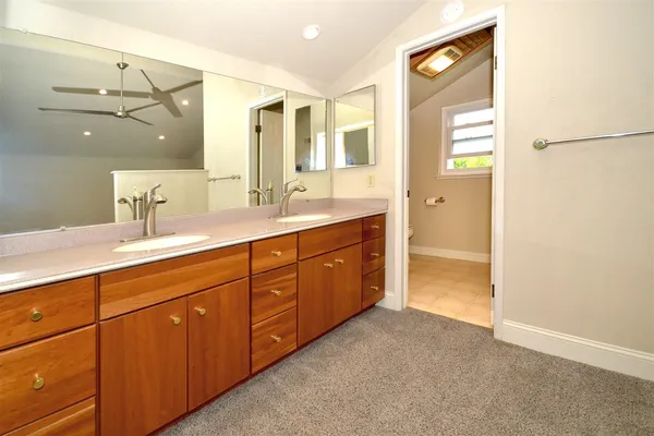 a spacious bathroom with a double vanity sink and mirror