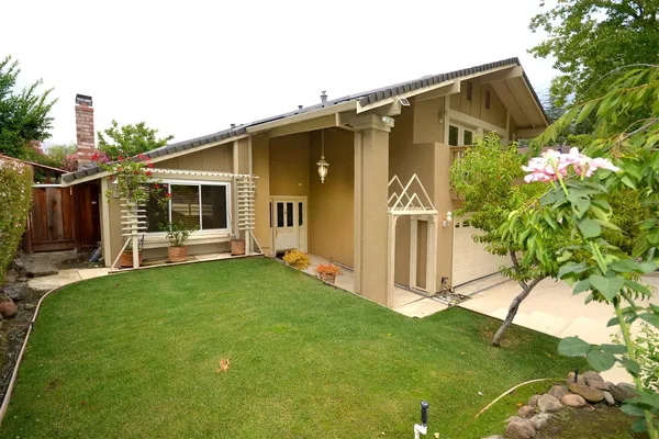 a front view of a house with garden