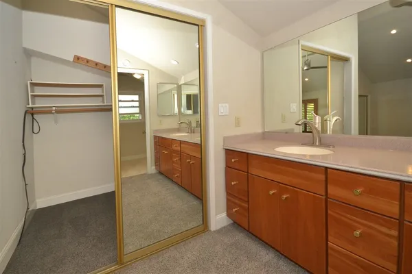 a bathroom with a granite countertop sink mirror and a