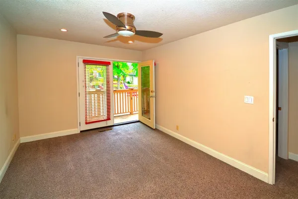 a view of an empty room and a window