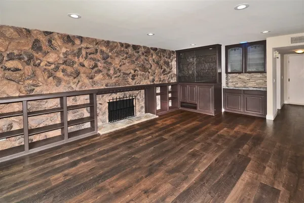 a view of kitchen with furniture and refrigerator