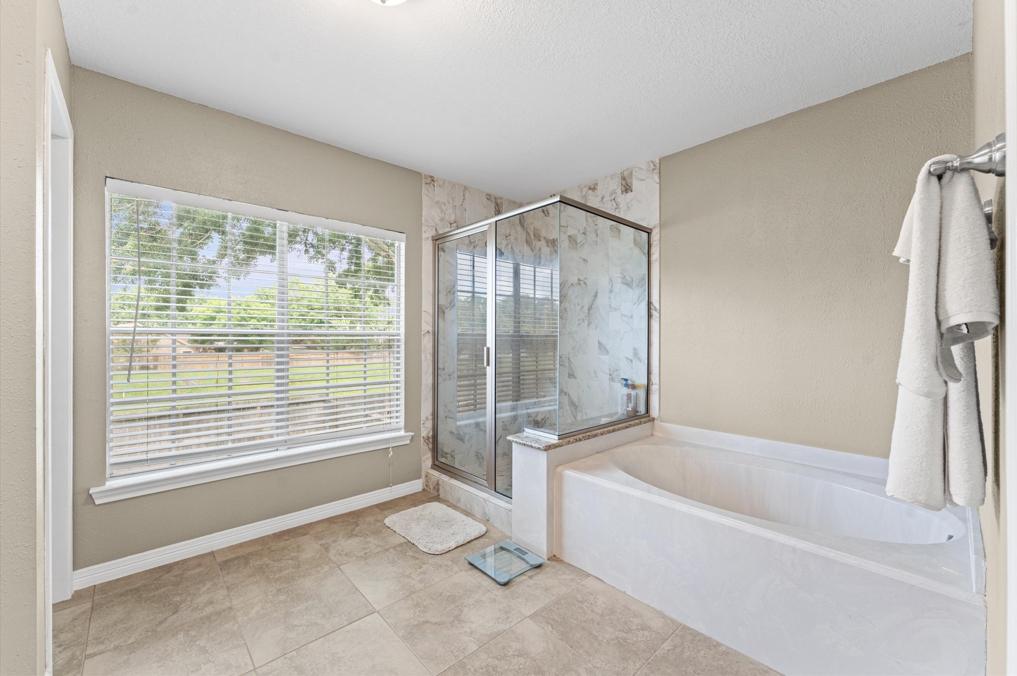 9903 Burntfork Street Houston, TX 77064 - Photo 15 of 25 Primary bathroom also comes with a separate shower and soaking tub.