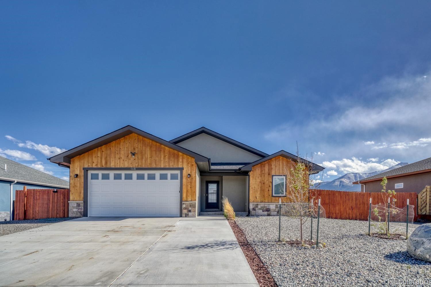 148 Grouse Road Buena Vista, CO 81211 - Photo 1 of 37 a front view of a house with a yard and garage