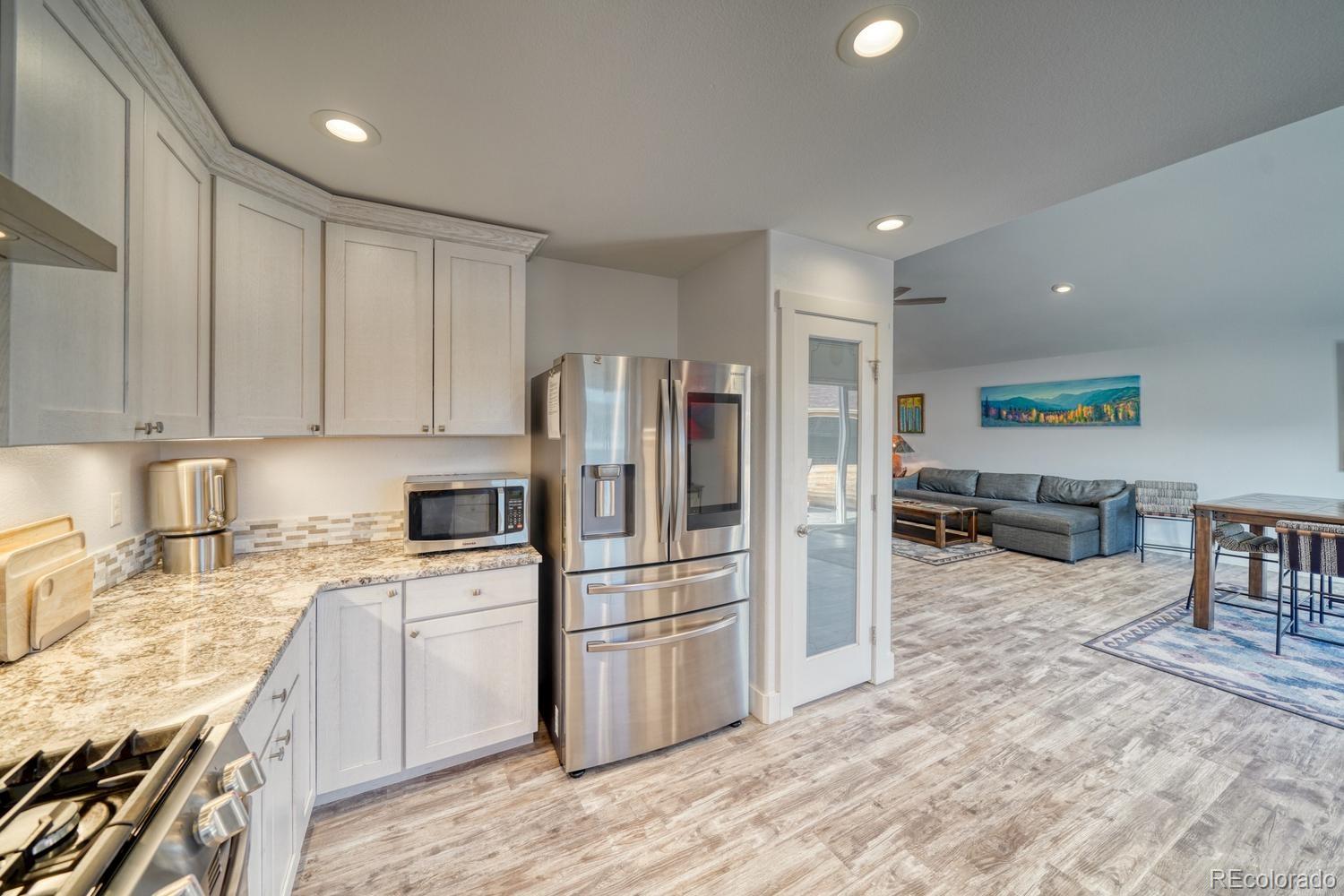 148 Grouse Road Buena Vista, CO 81211 - Photo 13 of 37 a kitchen with a refrigerator a stove and a sink