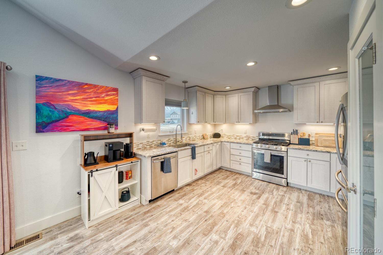 148 Grouse Road Buena Vista, CO 81211 - Photo 15 of 37 a large kitchen with stainless steel appliances granite countertop a stove and a sink
