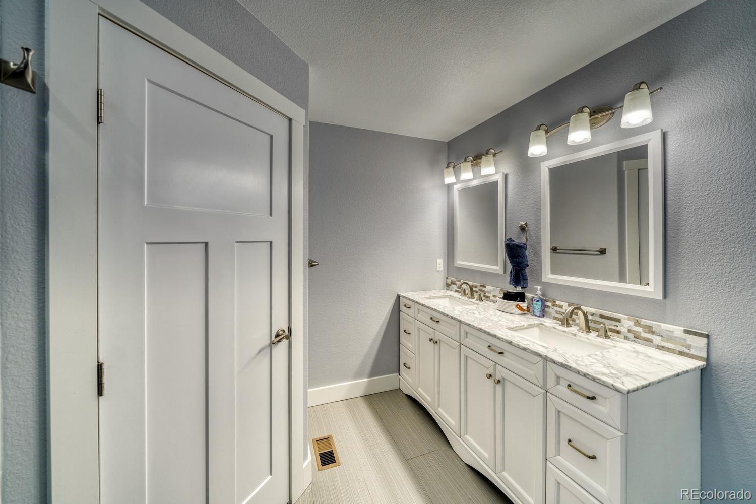 148 Grouse Road Buena Vista, CO 81211 - Photo 18 of 37 a spacious bathroom with a double vanity sink and a mirror