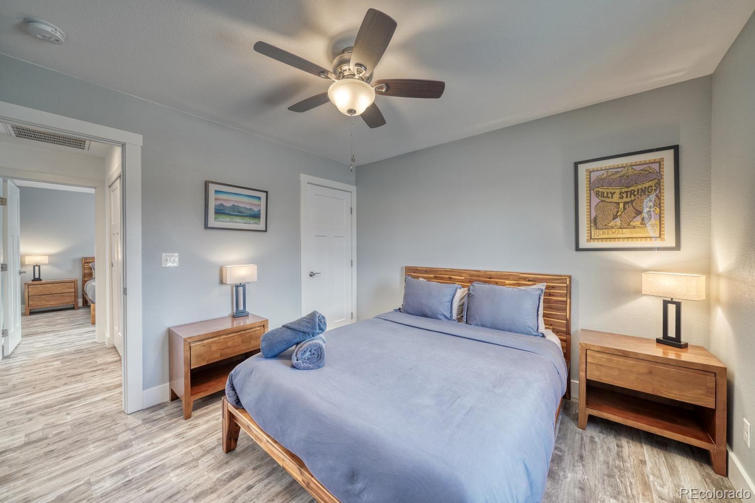 148 Grouse Road Buena Vista, CO 81211 - Photo 20 of 37 a bedroom with a bed and a chandelier
