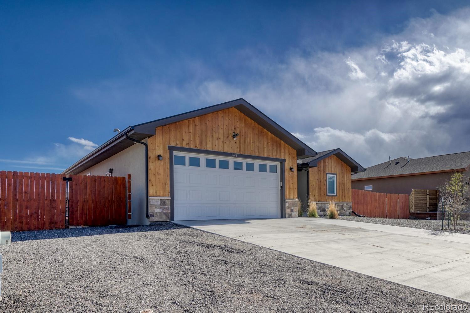 148 Grouse Road Buena Vista, CO 81211 - Photo 2 of 37 a front view of a house with a yard and garage