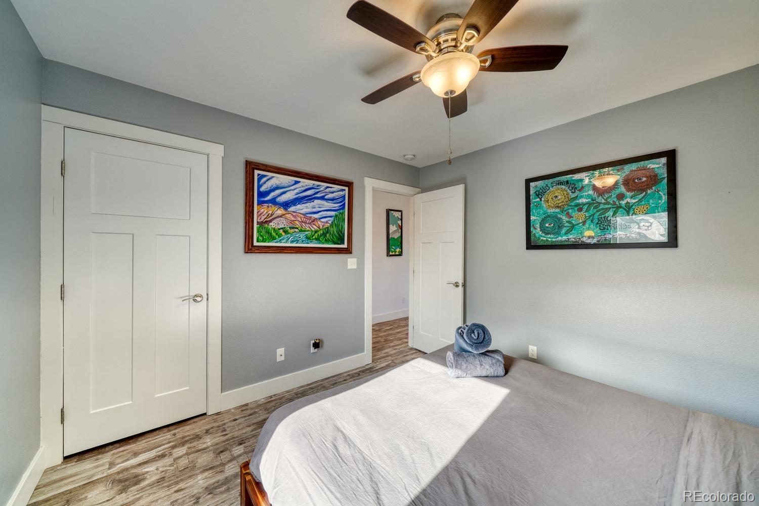 148 Grouse Road Buena Vista, CO 81211 - Photo 23 of 37 a bedroom with a large bed chandelier and a window
