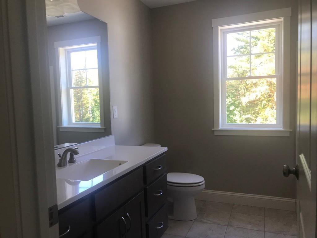 56 Clement Road Townsend, MA 01474 - Photo 14 of 23 a bathroom with a sink a toilet and a window