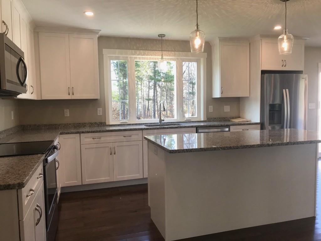 56 Clement Road Townsend, MA 01474 - Photo 4 of 23 a kitchen with granite countertop a sink a counter space appliances and cabinets