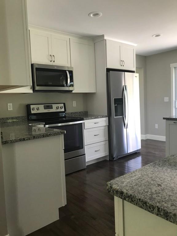 56 Clement Road Townsend, MA 01474 - Photo 5 of 23 a kitchen with stainless steel appliances granite countertop a refrigerator a stove a sink and white cabinets
