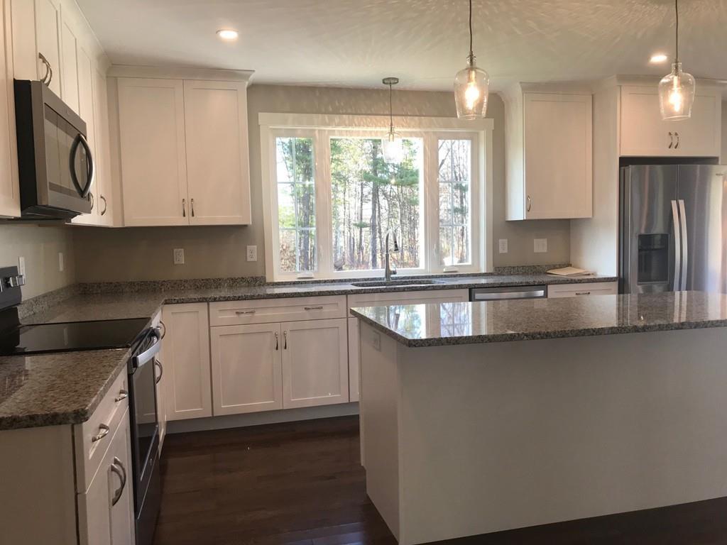 56 Clement Road Townsend, MA 01474 - Photo 6 of 23 a kitchen with granite countertop a sink a counter space appliances and cabinets