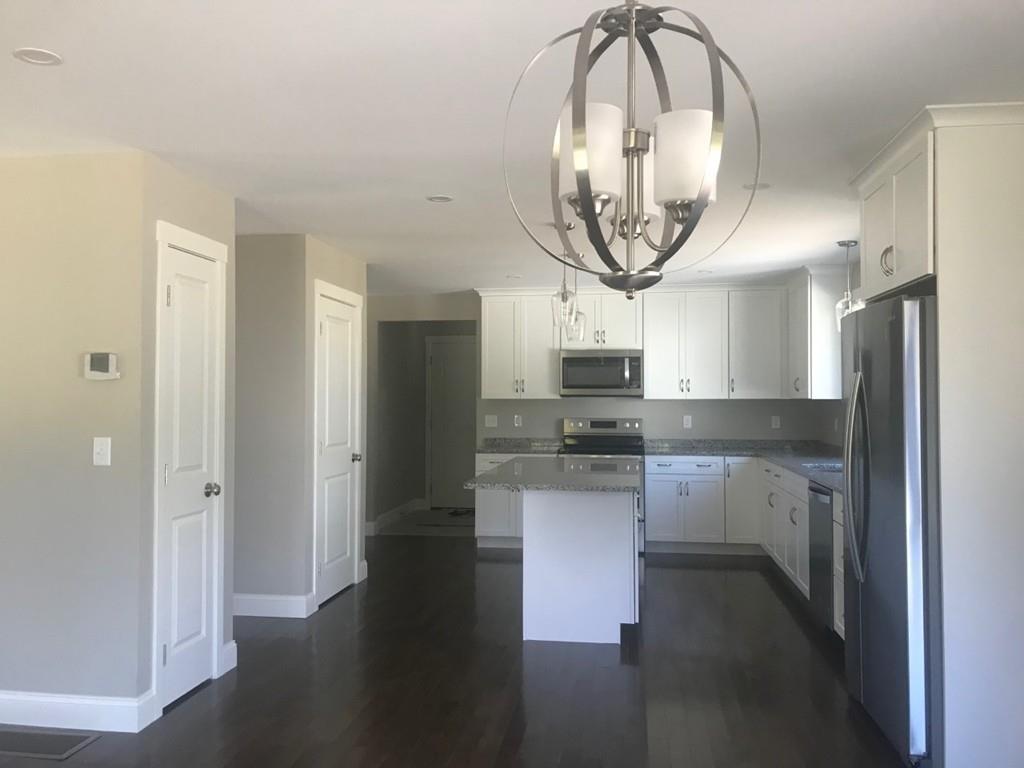 56 Clement Road Townsend, MA 01474 - Photo 9 of 23 a kitchen with stainless steel appliances a stove a refrigerator and a sink