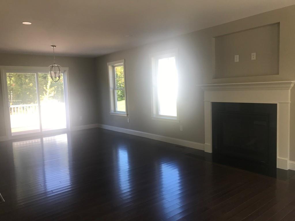 56 Clement Road Townsend, MA 01474 - Photo 10 of 23 a view of an empty room with wooden floor and a window