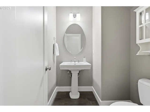 a bathroom with a sink toilet and a mirror