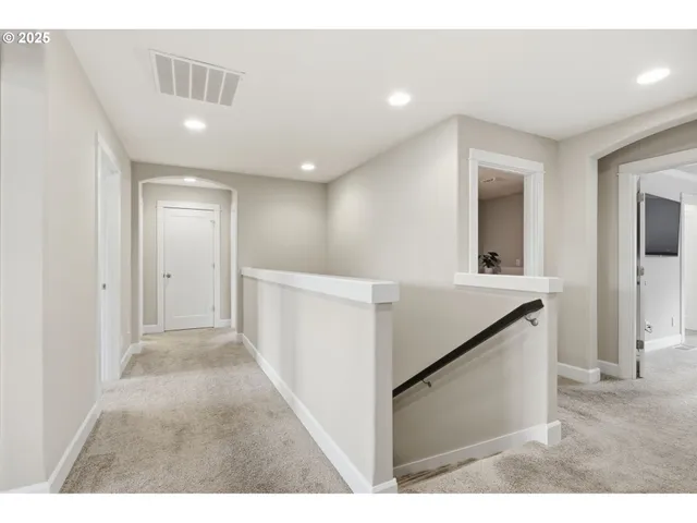a spacious bedroom with a bed and a chandelier