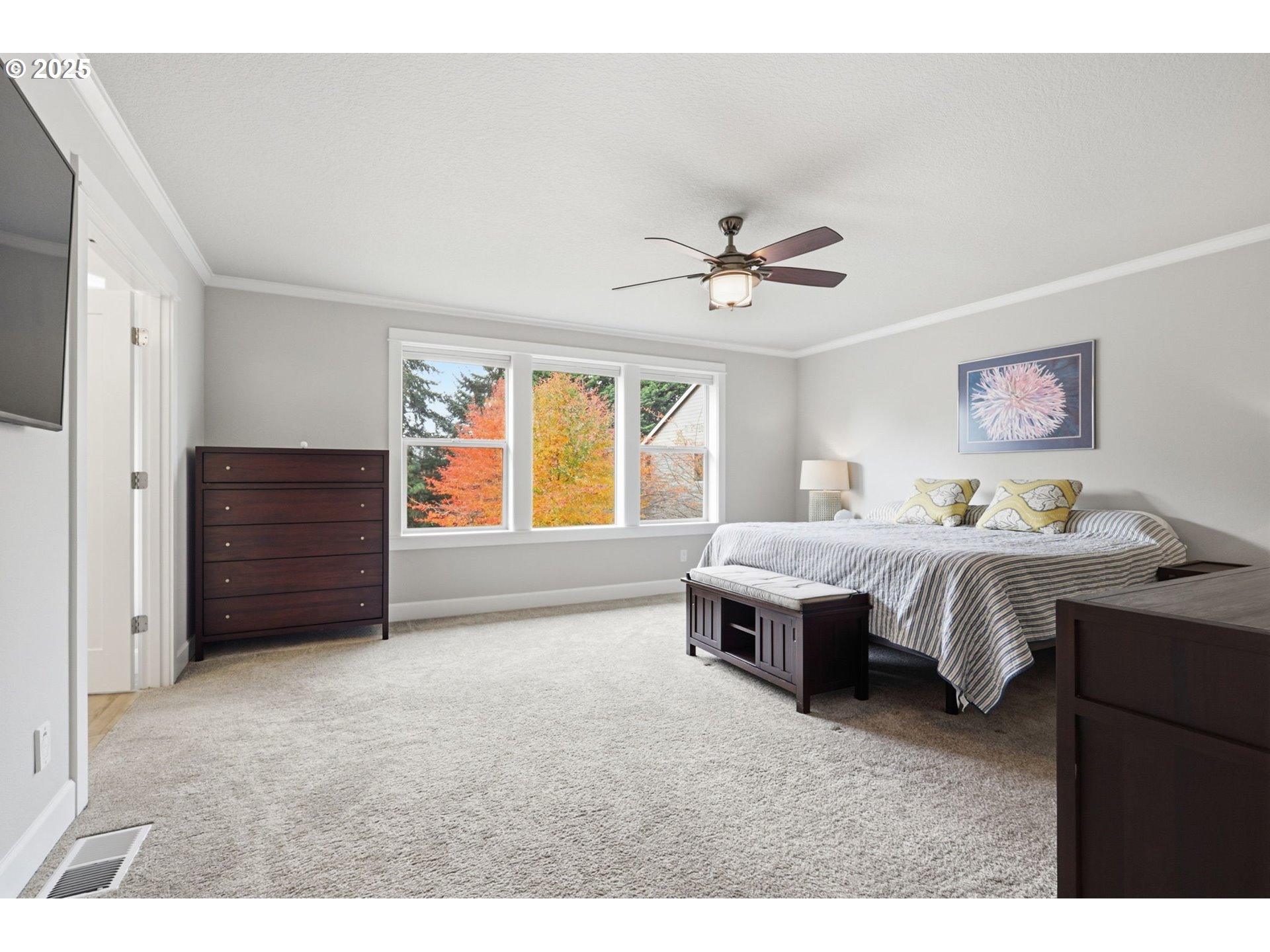 28337 Southwest Morningside Avenue Wilsonville, OR 97070 - Photo 18 of 48 a spacious bedroom with a bed and a chandelier