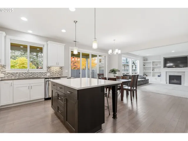 a kitchen with lots of counter space a sink appliances and dining table