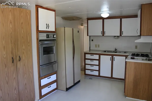 a kitchen with stainless steel appliances a refrigerator and cabinets