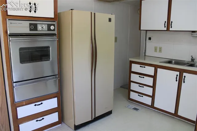 a kitchen with appliances and cabinets