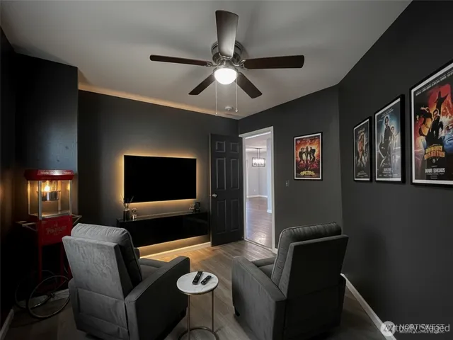 an empty room with closet and a chandelier fan