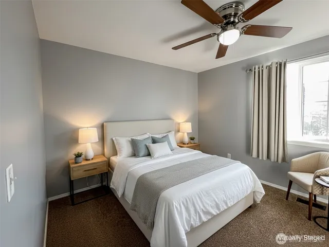 a view of a livingroom with a ceiling fan and hallway