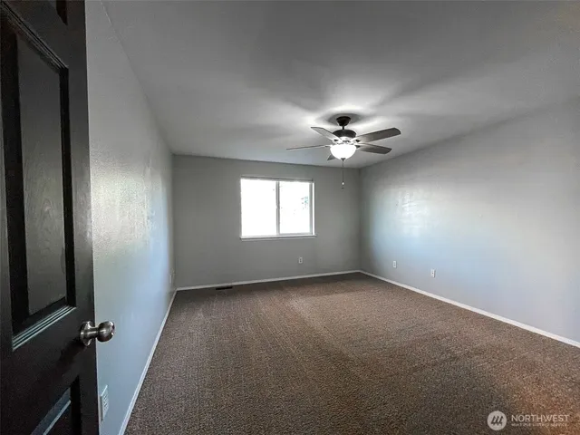 a bathroom with a sink a toilet a mirror a vanity and shower