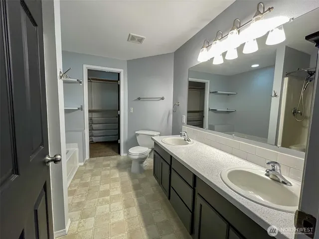 a bathroom with a bathtub and a toilet