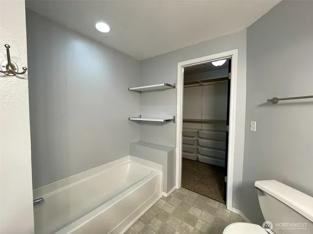 a patio with table and chairs and potted plants with wooden floor