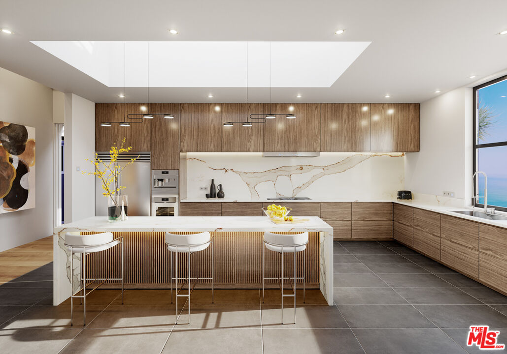 9522 Cotharin Road Malibu, CA 90265 - Photo 18 of 25 a kitchen with a sink and chairs