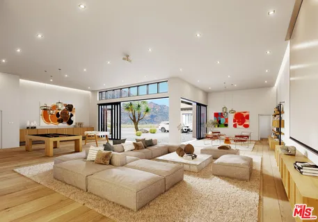 a view of a livingroom with workspace and a large window