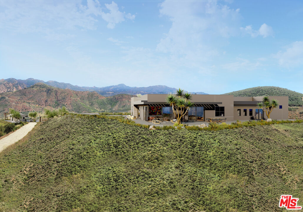 9522 Cotharin Road Malibu, CA 90265 - Photo 23 of 25 a view of a house with a yard and sitting area