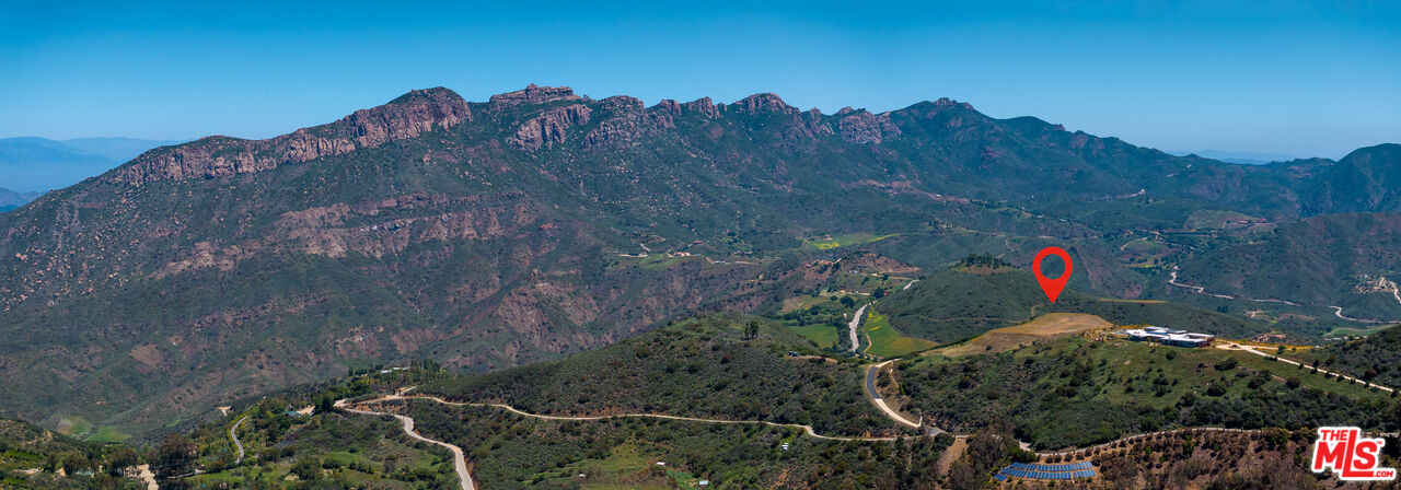 9522 Cotharin Road Malibu, CA 90265 - Photo 3 of 25 a backyard of a house with a mountain and a forest