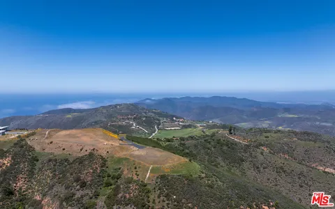 a view of a field with an ocean