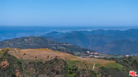a view of an ocean and a mountain