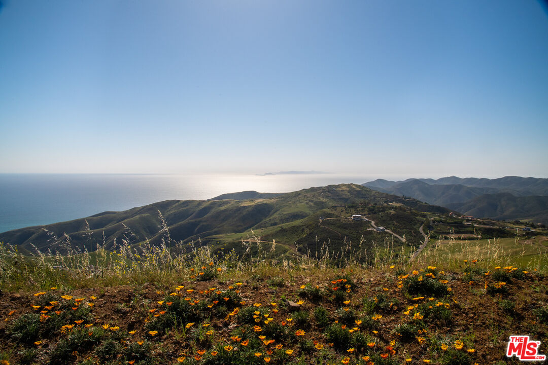 9522 Cotharin Road Malibu, CA 90265 - Photo 10 of 25 a view of a houses with a lake and mountains