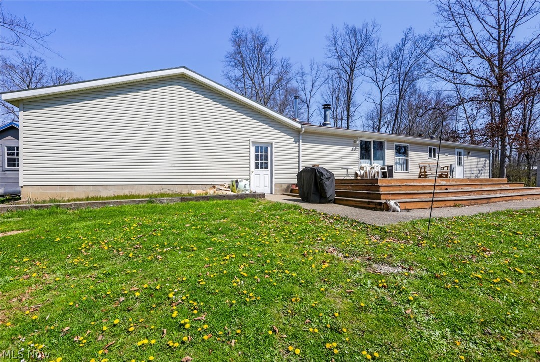 4502 Clover Road Cumberland, OH 43732 - Photo 2 of 38 Back of house featuring a yard and a patio area