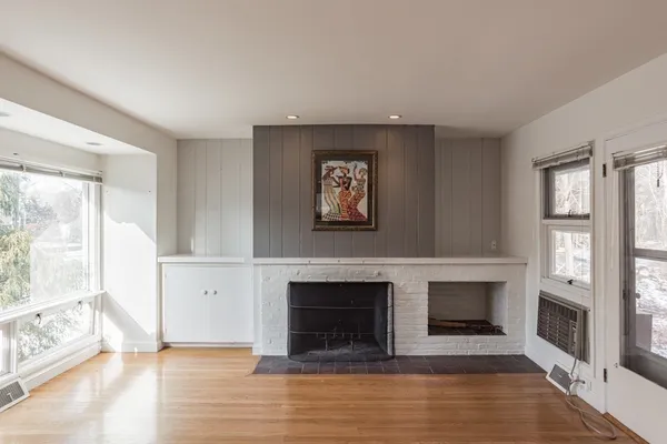 a view of a livingroom with a fireplace and window