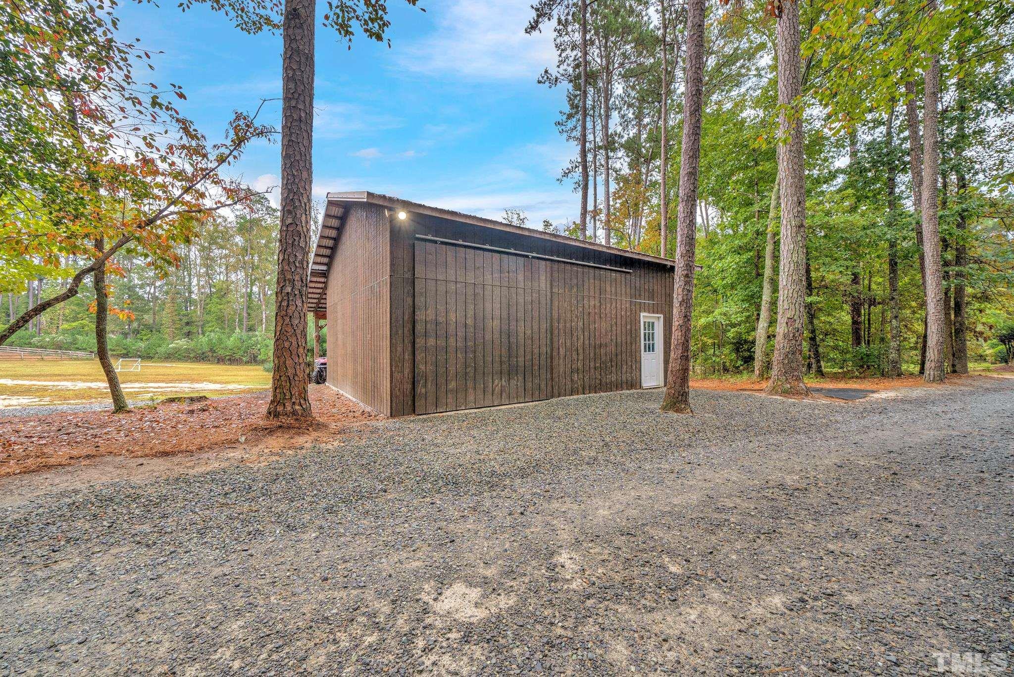 3249 Grand Oak Lane New Hill, NC 27562 - Photo 11 of 65 a view of a house with backyard and trees