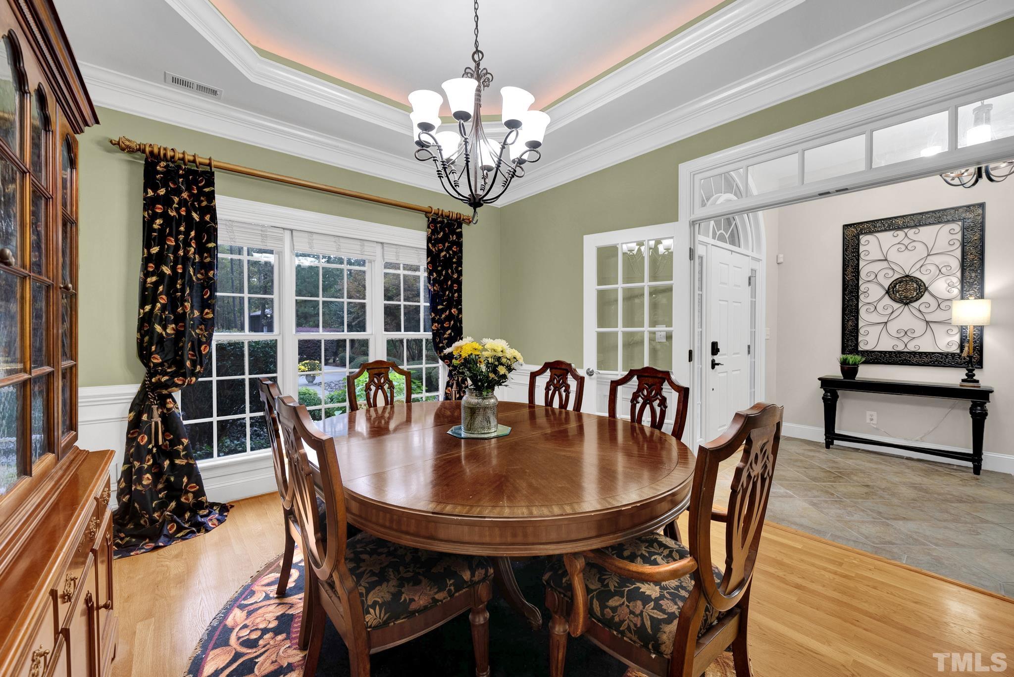 3249 Grand Oak Lane New Hill, NC 27562 - Photo 14 of 65 a dining room with furniture a chandelier and window