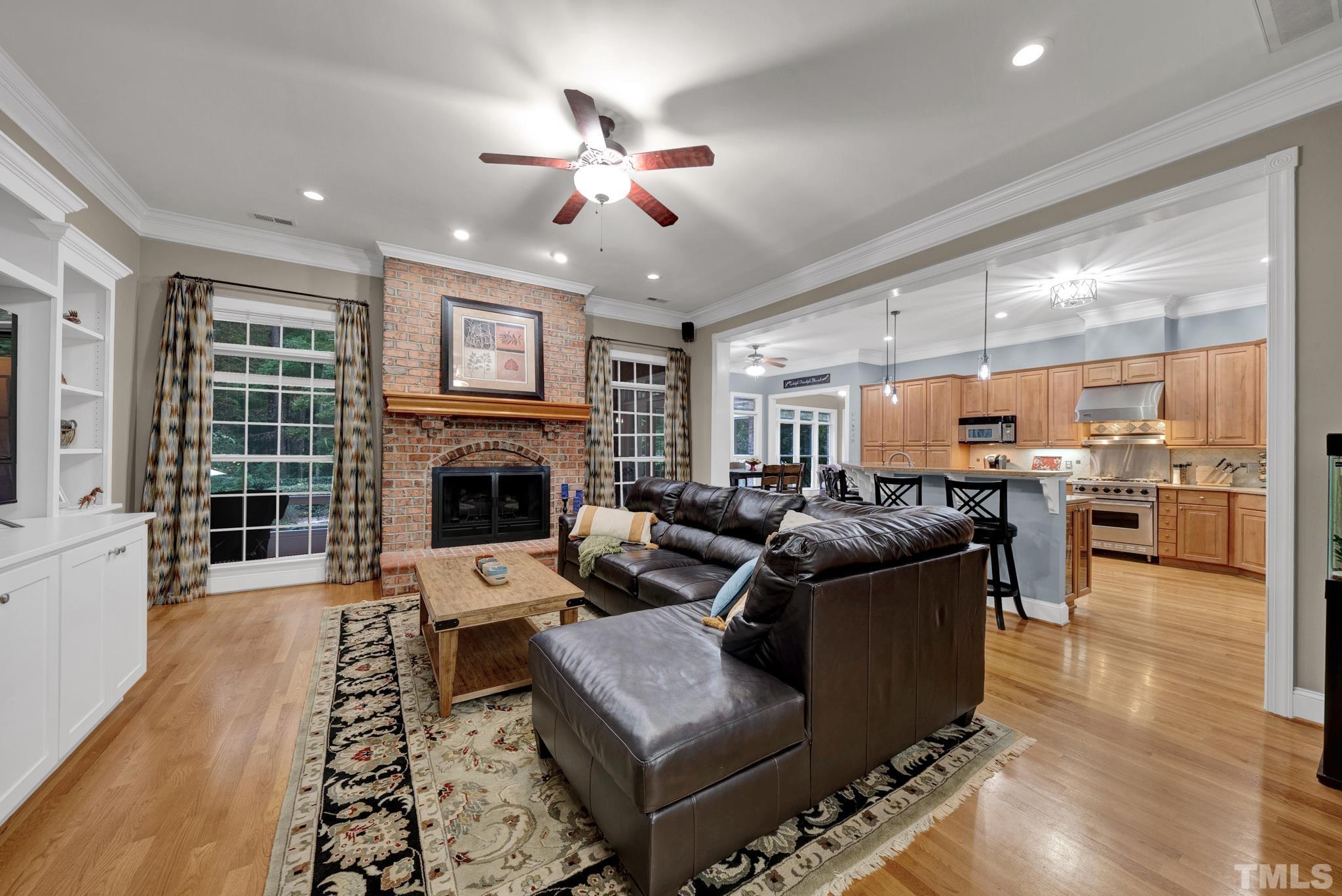 3249 Grand Oak Lane New Hill, NC 27562 - Photo 15 of 65 a living room with furniture wooden floor and a fireplace