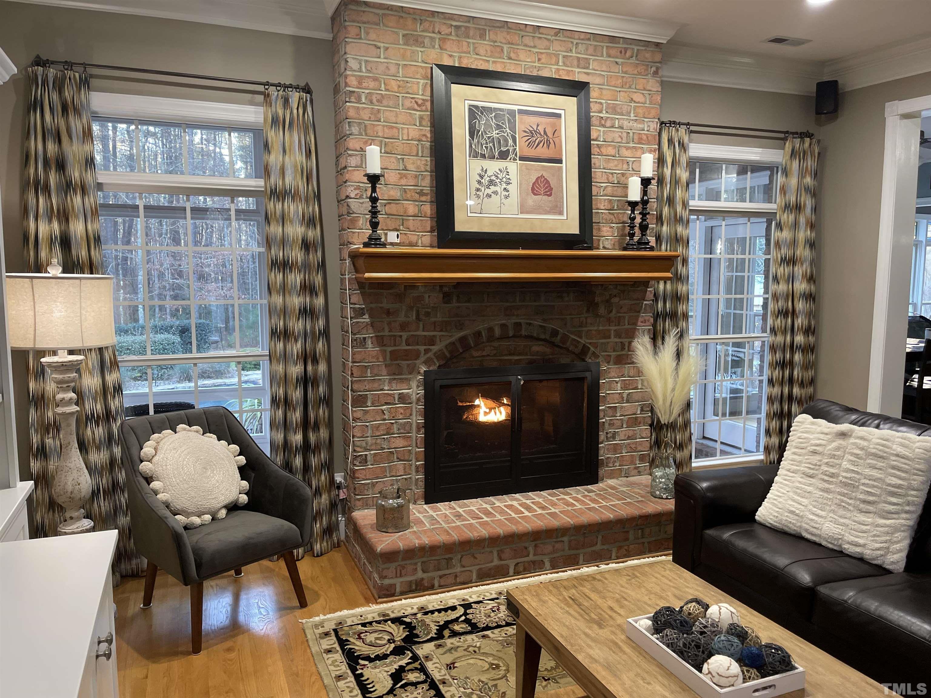3249 Grand Oak Lane New Hill, NC 27562 - Photo 16 of 65 a living room with furniture and a fireplace