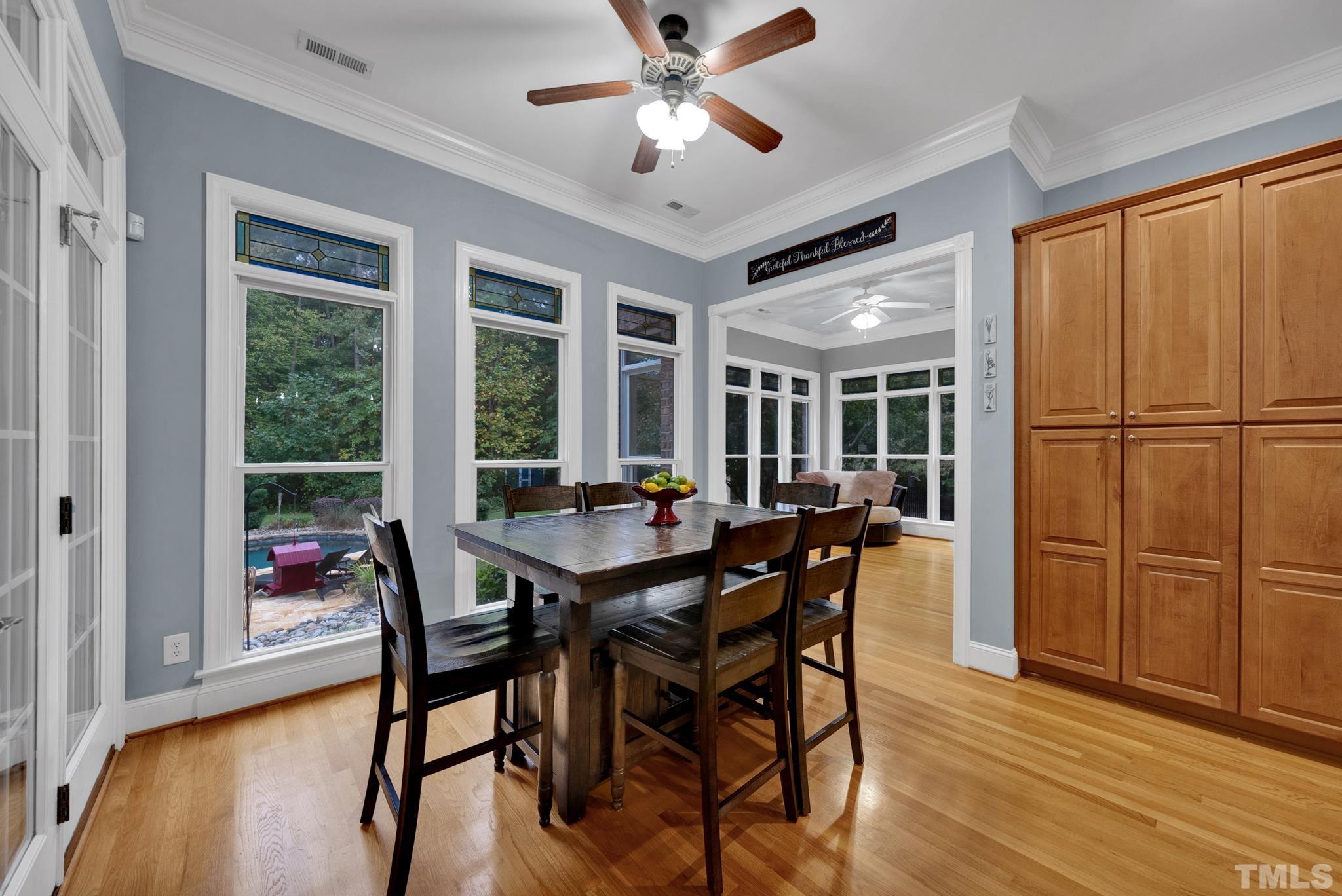 3249 Grand Oak Lane New Hill, NC 27562 - Photo 19 of 65 a view of a dining room with furniture window and wooden floor